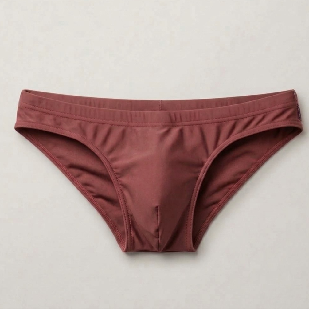 The Essential men's swim brief in Clay — fully lined, contoured fit, flat lay